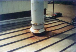 Exhaust flues that discharge gases from burning fossil fuels can cause a corrosive acid rain microenvironment. The effect on a metal roof must be considered when exploring protective options. Photo courtesy Metal Roof Advisory Group