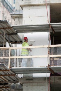 A continuous air barrier is installed at the Ronald McDonald House in Chicago, in a one-coat application by spraying or power-rolling, over concrete. A fluid-applied air barrier system was specified for this structure to address its many inside corners and protrusions, as well as numerous surface irregularities due to its poured-in-place concrete and concrete block construction. The air barrier is vapor permeable to allow diffusion drying. Photo courtesy Dupont 