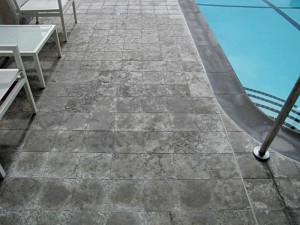 This badly spalled limestone tile is from a high-rise exterior suspended deck. Although it had a drainage mat over a waterproof membrane, the latter was not properly sloped to the drains and weep holes were plugged. This resulted in the stone being subjected to continuous moisture that caused the spalling.