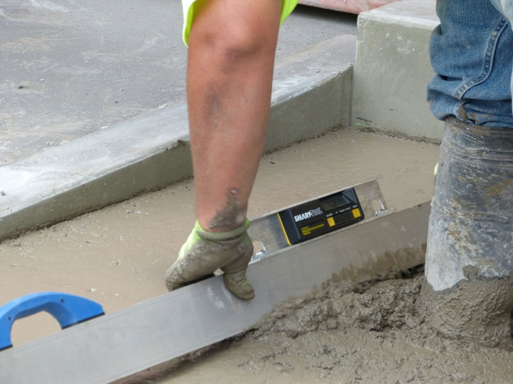 Initial screeding: second-phase bump-cutting using a digital level mounted on a mag beam screed.