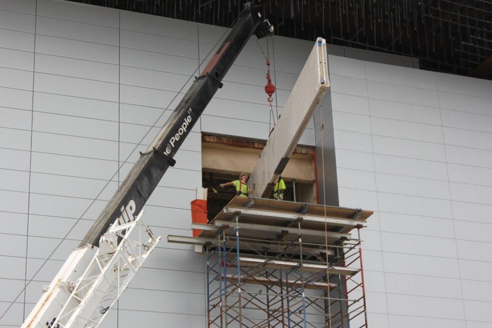 This crane and scaffolding were part of an unusual installation process as workers had to get the 12.7-m (41 ½-ft) operable partition panels inside the Grand Ballroom on the top floor. Photo courtesy Crawford Door Sales of Nashville Inc.