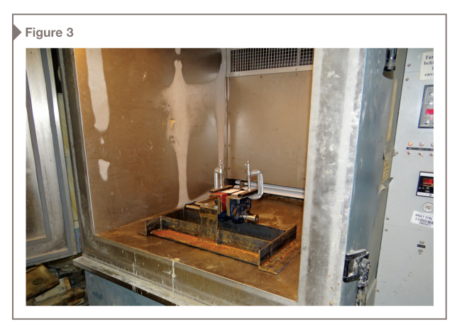 The testing apparatus was designed to fit into a standard chest freezer, but an environmental chamber is used at the lab.