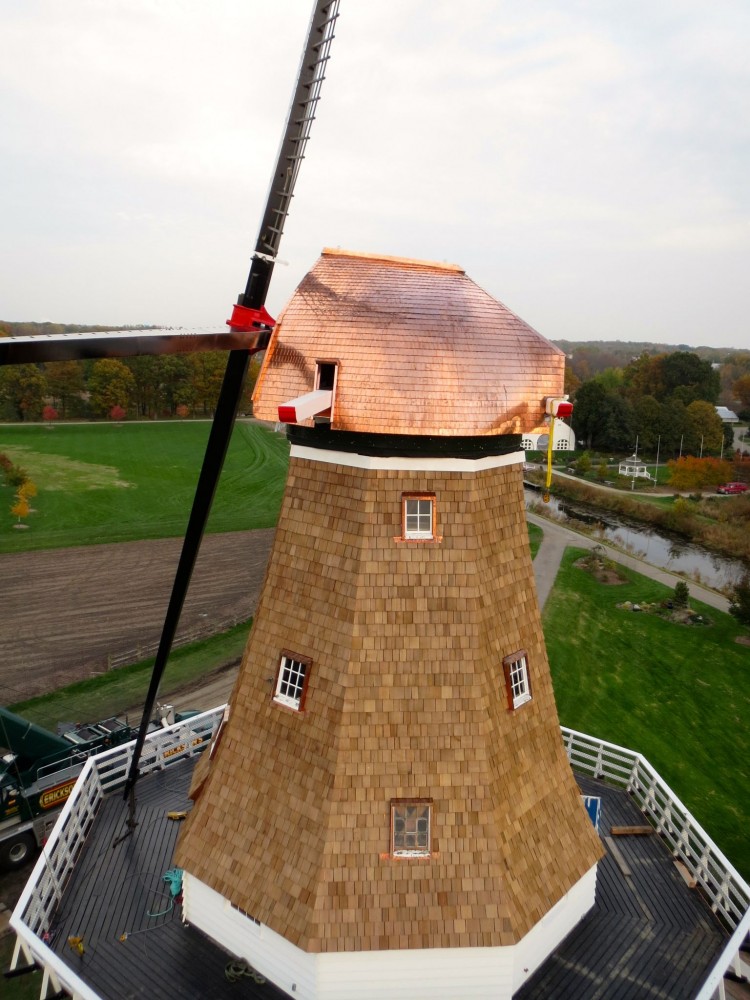 Moved decades ago from Holland (Netherlands) to Holland (Michigan), this 18th century windmill has a cap covered by nearly 2260 kg (5000 lb) of sheet copper, individually cut and hemmed from 20-oz. sheet copper before being secured with brass screws. In many cases, the uniquely curved shape of the cap required shingles be rolled by hand to ensure they lay flat against the roof contours. Photo © Brian Blank