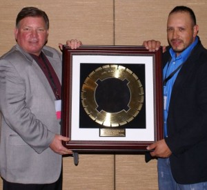  Tomas Ramos, project supervisor at Concrete Stabilization Technologies, receives the 2014 Operator of the Year (Iron Man) Award from Roberts.