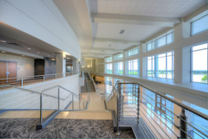 The thermally improved curtain wall and sunshades help keep out the Texas heat, and the airfoil blades and tubular fascia direct wind and water away from the building.