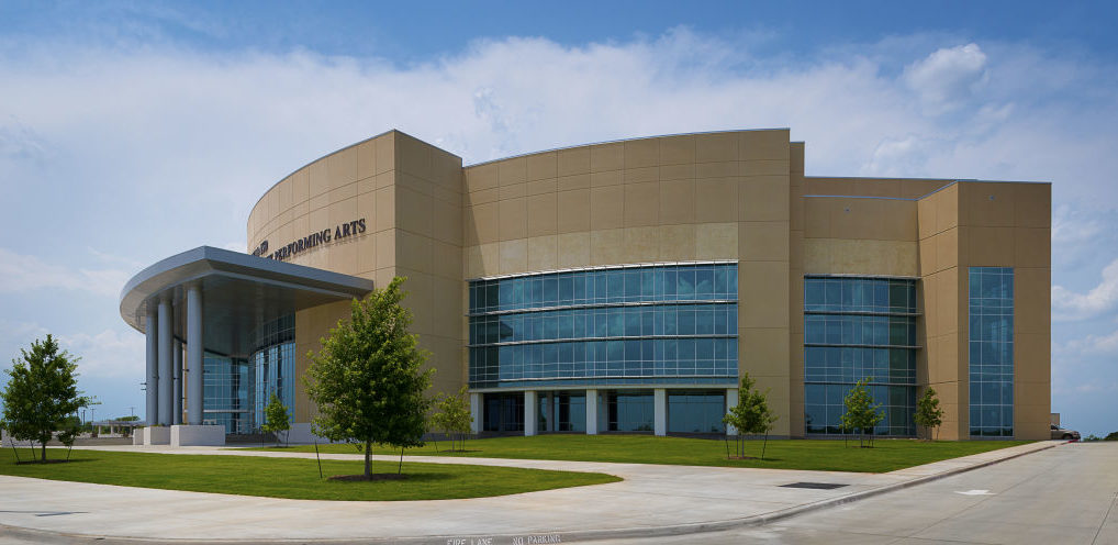 Mansfield Center for Performing Arts in Texas features oversized entrances matched with large, curving spans of glass and aluminum storefront and curtain wall with sun shades. Photos courtesy Huckabee and Tubelite Inc.