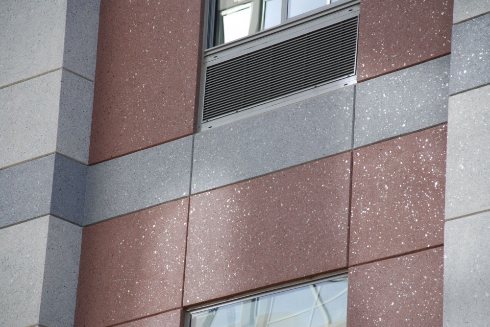 The picture is an example of a specialty finish replicating the look of granite using a ceramic bead, mica chips, and clear binder. This installation is on the Spring Hill Suites in Alexandria, Virginia.