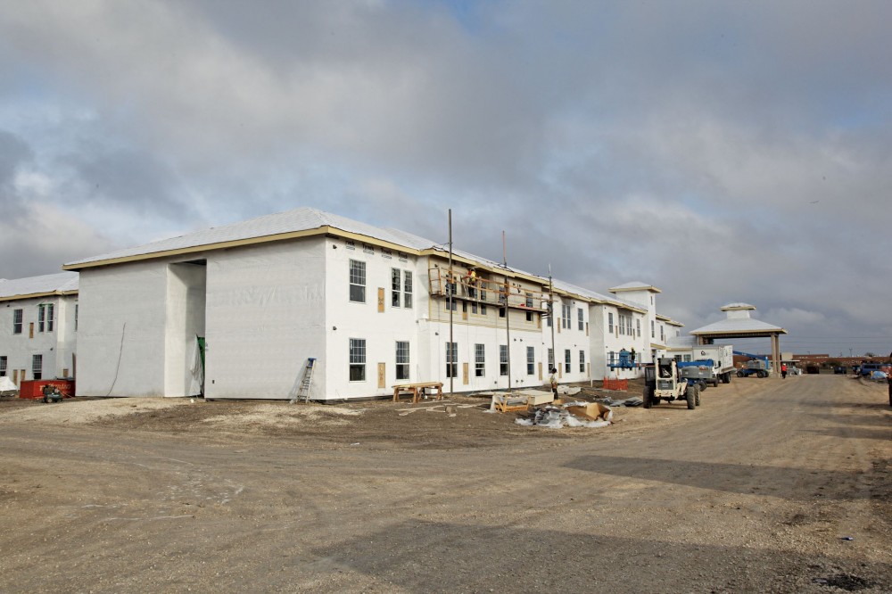 A mechanically-fastened air and water barrier system is installed over the exterior sheathing. Fluid applied air barrier was also used for concrete masonry unit (CMU) portions of this project (not visible in the picture). Proper integration between the two air barriers used for CMU and gypsum-covered metal stud walls was critical for continuity and structural integrity.