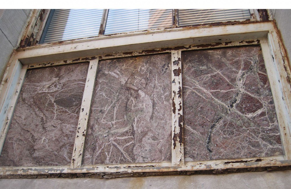 This is the original marble in the framed opening. Not only is there a crack in the panel to the right along one of the natural soft veins in the stone, but the marble had also lost its luster and burgundy color.