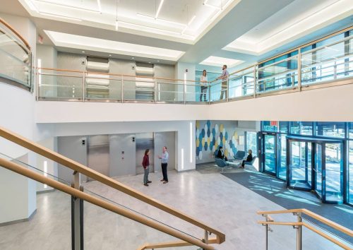 New lighting helped open up National Development’s two-story lobby, creating a brighter space upon entry. Photo by Warren Patterson Photography