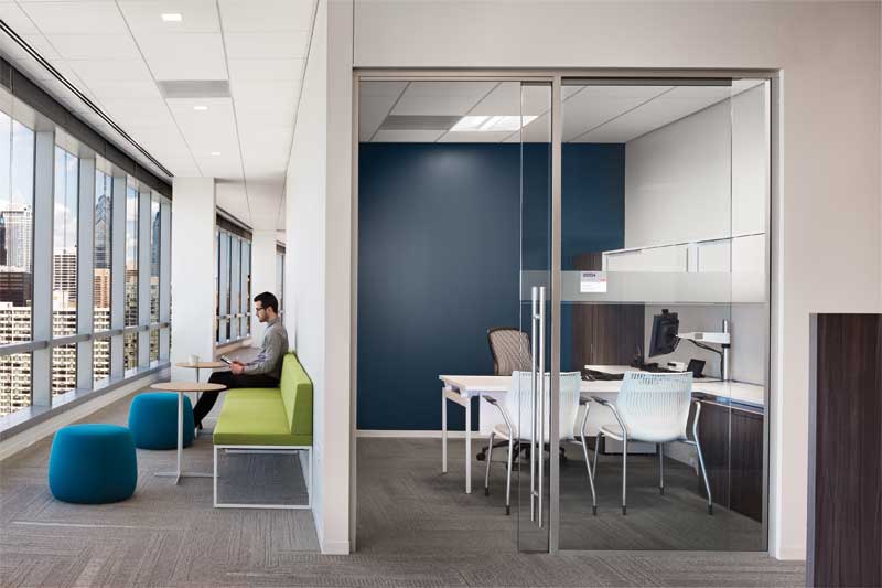 In the open corridor work area, 0.95 NRC fiberglass panels provide maximum sound absorption but are virtually indistinguishable visually from the mineral fiber panel (0.70 NRC, 33 CAC) featured in the enclosed office at FMC Corporation.