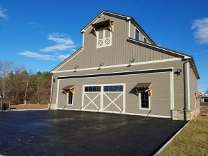 The hydraulic door employed at a farm hangar in Purcellville, Virginia, lifts 5 m (16 ft) upward to give easy access to the owner’s helicopter. Photo courtesy Schweiss Doors