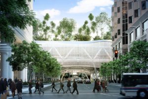 White, veiled pedestrian bridge seen over city street.