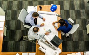 Group of professionals looking at blueprints.