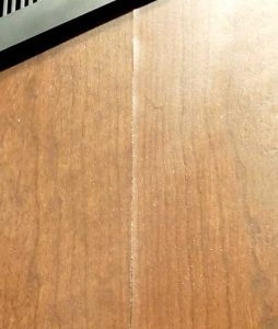 Buckling occurring at a joint in wood veneer paneling. The same failure can occur in laminate panels. Photo © Mitchel Taylor