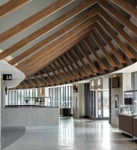 Lightweight extruded aluminum beams feature a wood look and guide visitors through the concourse around the interior bowl.