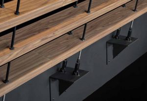 To ensure long-term durability for the shelf wall, all the wood-finished aluminum components were designed, engineered, and fabricated in-house.