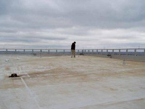 This image shows a failed single-ply roofing system. Note the elevated roof membrane hiding the fall protection anchor.