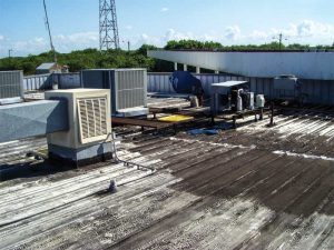 These images show a roof before and after recoating.