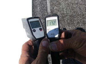 Thermometers show the temperature differential between a typical built-up asphalt roof (78 C [172 F] ) versus a white reflective roof coating (35 C [95 F]).