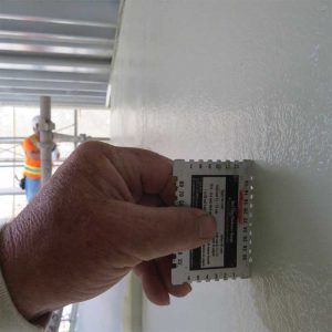 Figure 5: Verifying the thickness of the waterproof/crack isolation membrane during application.