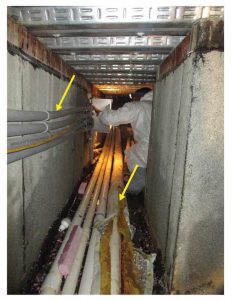 Figure 5: Horizontal utility lines with minimal clearance above and adjacent to waterproofing in interstitial space.