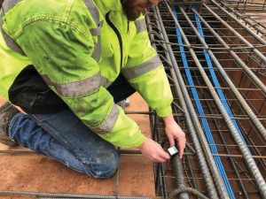 Sensors are attached to the reinforcing steel prior to concrete placement. In this case, near the post-tension (PT) cables.