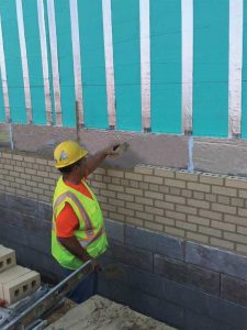 Continuous insulation (ci) is installed on the inner wythe’s outside face. In this configuration, it serves as the first line of defense against heat loss from the building to the outdoors.