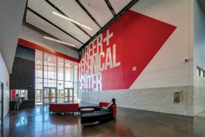 The Arlington Independent School District’s Dan Dipert Career + Technical Center in Texas showcases its school colors throughout its exterior. The aluminum panels are finished using 70 percent polyvinylidene fluoride (PVDF) coatings in gray and three custom reds, as well as clear anodize. Photo © Chad M. Davis, AIA, NCARB, LEED AP. Photo courtesy Linetec and Tubelite Inc.