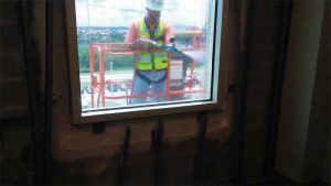 A high-pressure spray rig simulates wind-driven rain conditions on a mockup during the retrofit of the Brevard County Courthouse in Viera, Florida.