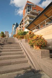 A granite stairway and bicycle ramp at the Banks park in Cincinnati, Ohio, provides resistance to salt and flood damage as well as a color and texture that enhance the space’s visual appeal. Photo © Patrick McCue Photography