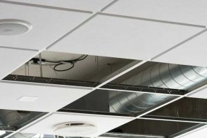 Modular acoustic ceilings comprise a metal suspension grid, ceiling panels, and various building system elements, such as light fixtures, air terminals, sprinklers, and speakers. Even when the ceiling panels offer high sound absorption, these components may result in unwanted sound transfer.