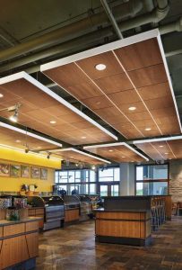 Wood is gaining use in ‘free-floating’ acoustical clouds, especially in exposed structure applications. Wood clouds must be perforated and backed to obtain acoustical benefits.