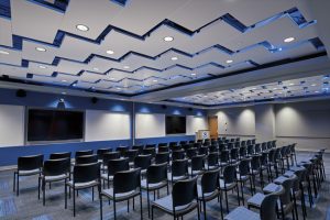 At the National Oceanic and Atmospheric Administration’s (NOAA) National Logistics & Reconditioning Center in Grandview, Missouri, metal ceiling panels installed diagonally in a herring bone pattern create a signature space. Photo courtesy Armstrong Ceiling & Wall Solutions