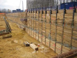 SOE wall should have a planar surface to apply the blind-side waterproofing and structural shotcrete foundation wall.