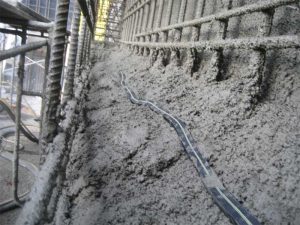 Bentonite strip waterstop installed in plastic shotcrete at the top surface of a working lift.