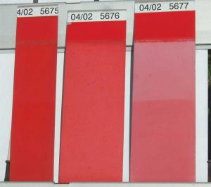 Figure 5: Appearance of coatings made with a red pigment and various type of resins, after seven-and-a-half years of exposure in south Florida. From left to right: 70 percent PVDF (solvent), 70 percent PVDF (latex), and two-component acrylic urethane. Panel sections from top to bottom: original color (covered by flap) and unwashed and washed portions.