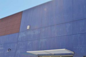 Figure 6 A college building in Vacaville, California, eight years after installation of an acrylic latex. The photo of the north-facing exterior wall shows significant chalking and erosion, exposing areas of the concrete façade. Board members of the college expressed the need for recoating as a key effort to build their brand and attract students. Image courtesy APV Engineered Coatings