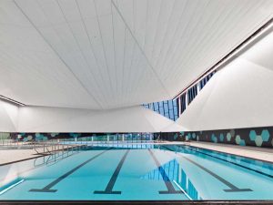 The Emerald Hills Leisure Centre, Sherwood Park, Alberta, Canada, features large-format acoustical ceiling panels that not only provide a cohesive, monolithic look, but also can withstand changes in temperature and moisture levels without warping or sagging. Photos © CertainTeed