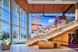 The Clemson University Allen N. Reeves Football Operations Complex, South Carolina, is a Leadership in Energy and Environmental Design (LEED) Silver facility that sets a new standard for the student-athlete experience. It features large-format, acoustical ceiling panels throughout several communal spaces.