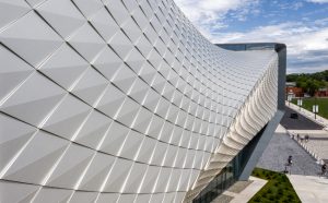 The museum façade consists of over 9000 folded anodized, diamond-shaped aluminum panels.