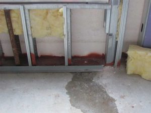 Water leakage during the initial performance verification testing of an installed window assembly. Leakage was attributed to omission  of a critical seal. Photo courtesy WJE