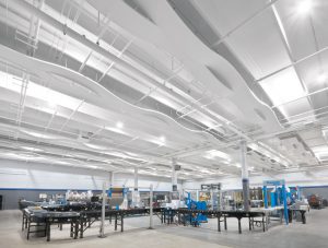 Atlantic Packaging, Charlotte, North Carolina, adds aesthetics and acoustics to its remodeled solution center with an undulating ceiling system. Photo courtesy Armstrong Ceiling Solutions