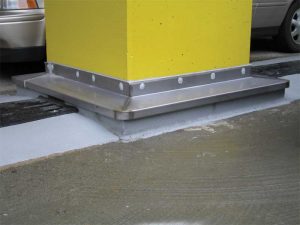 Figure 7: Expansion joint repair at column using a curb around column, raising the shear portion of the expansion joint above deck.