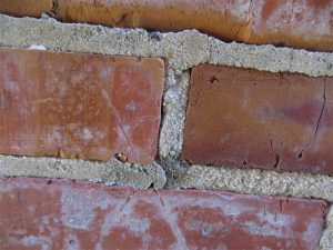 Although the existing pointing mortar is cracked and weathered, samples can be obtained to determine its composition. (Some non-matching repointing mortar is also visible in this photo.) Photos © David S. Patterson, AIA