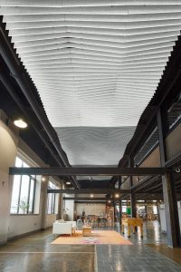 The Stone Independent School in Lancaster, Pennsylvania, added a trio of ceiling treatments to improve the acoustic environment in their new location which used to be a manufacturing facility. Photos courtesy Armstrong Ceiling Solutions