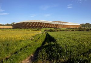 Zaha Hadid Architects’ design for the all-timber Ecopark Stadium in Gloucestershire, England, has received approval by the English Football League. Rendering courtesy MIR