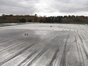 Figure 1: Blocked roof drain leading to standing water and de-granulation of cap sheet. Photos courtesy Morrison Hershfield