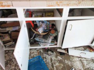 After the floodwaters had finally gone down, people started cleaning their damp and muddy houses before mold set in.