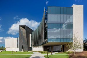 Another shot of the facade. The bronze-clad portal is visible along with the perforated bronze solar screens layered over the glazed areas.